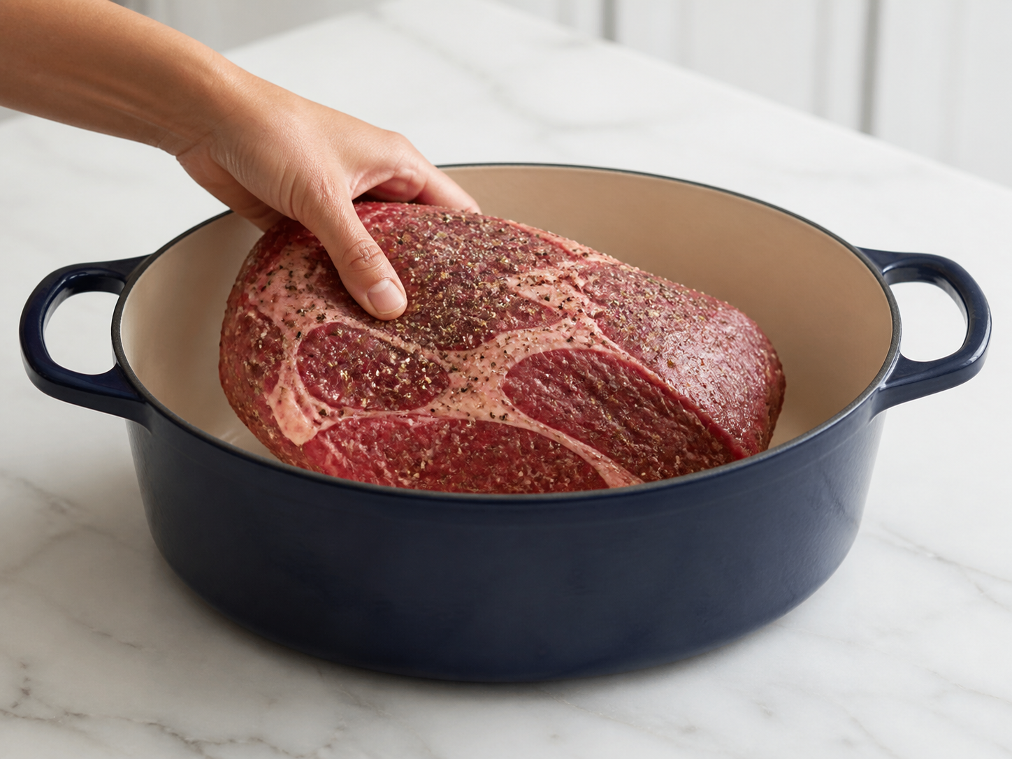 Seasoned chuck roast placed in a Dutch oven